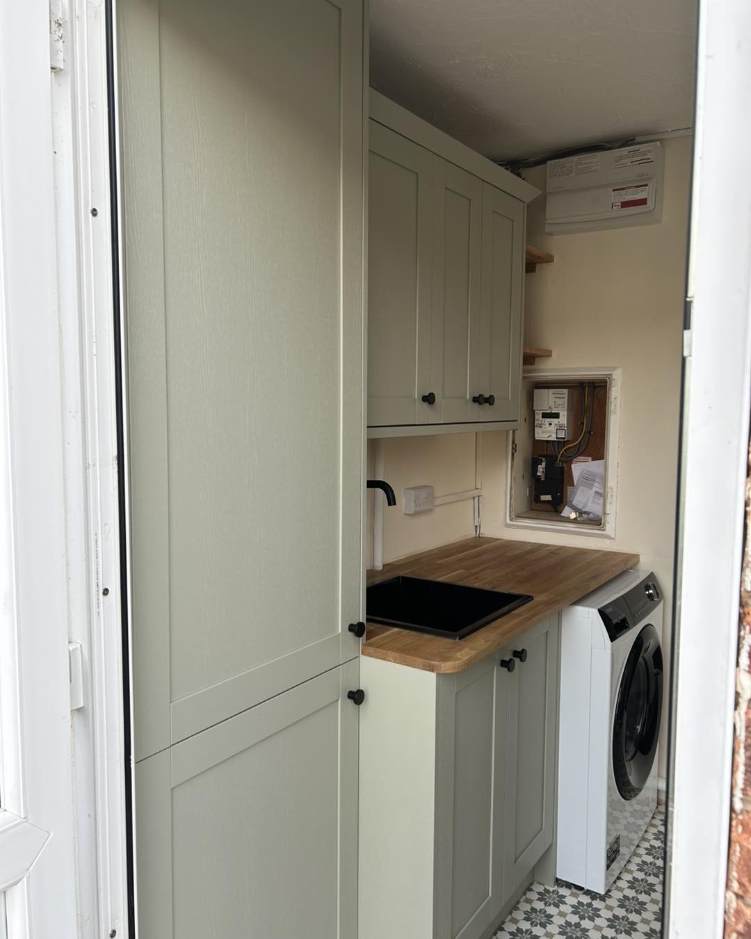 Utility room after, tall cupboard beside the base units
